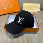 Black Louis Vuitton baseball cap with LV monogram emblem on front, curved brim.