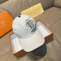 Louis Vuitton white cap with black flower logo and embroidered text