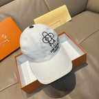 Louis Vuitton white cap with black flower logo and embroidered text