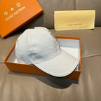 Louis Vuitton white baseball cap with black button and side profile