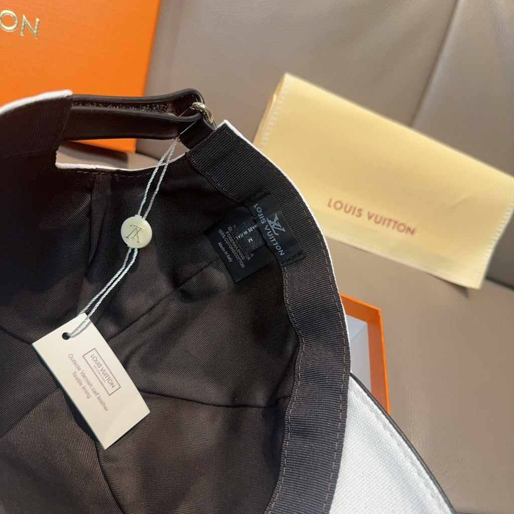 Louis Vuitton black cap with adjustable strap and attached hang tags