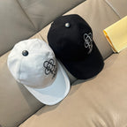 Louis Vuitton white and black caps; black cap shows a small flower emblem