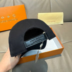 Louis Vuitton cap, black with brand-printed adjustable strap and clasp