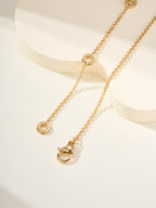 Gold chain necklace with round medallion charms and small dangling details