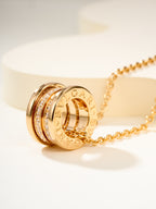 Gold hoop pendant necklace with engraved band detail and pavé highlights