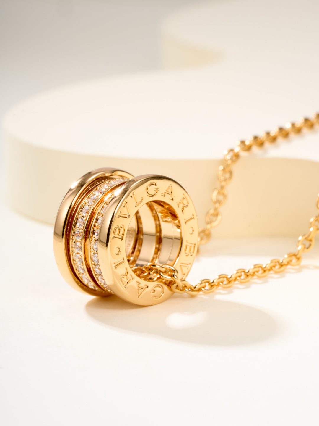 Gold hoop pendant necklace with engraved band detail and pavé highlights
