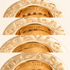 Gold stacked ring bands with engraved lettering and inset crystal pavé