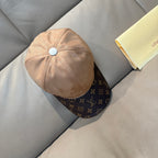 Louis Vuitton two-tone baseball cap in beige with light blue button and dark brim.
