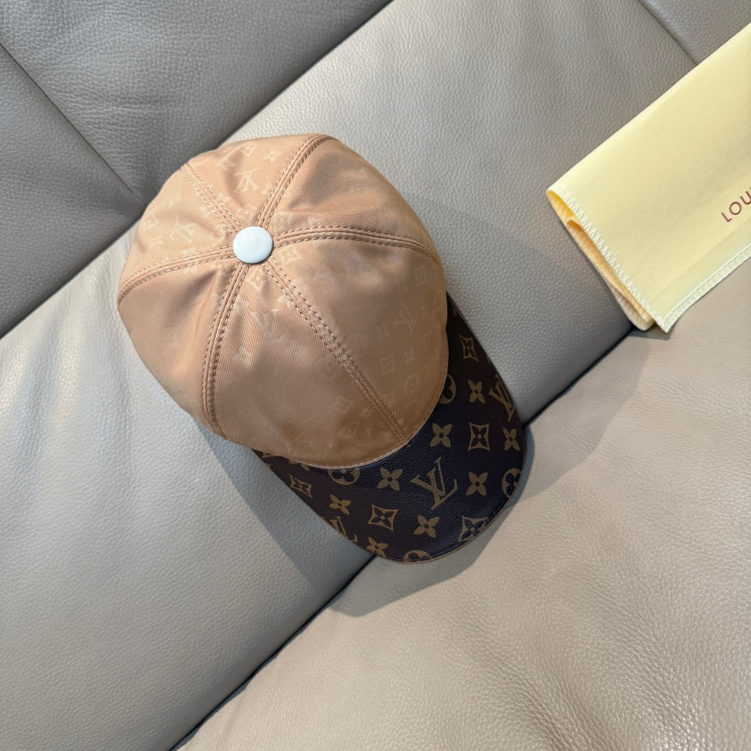 Louis Vuitton two-tone baseball cap in beige with light blue button and dark brim.