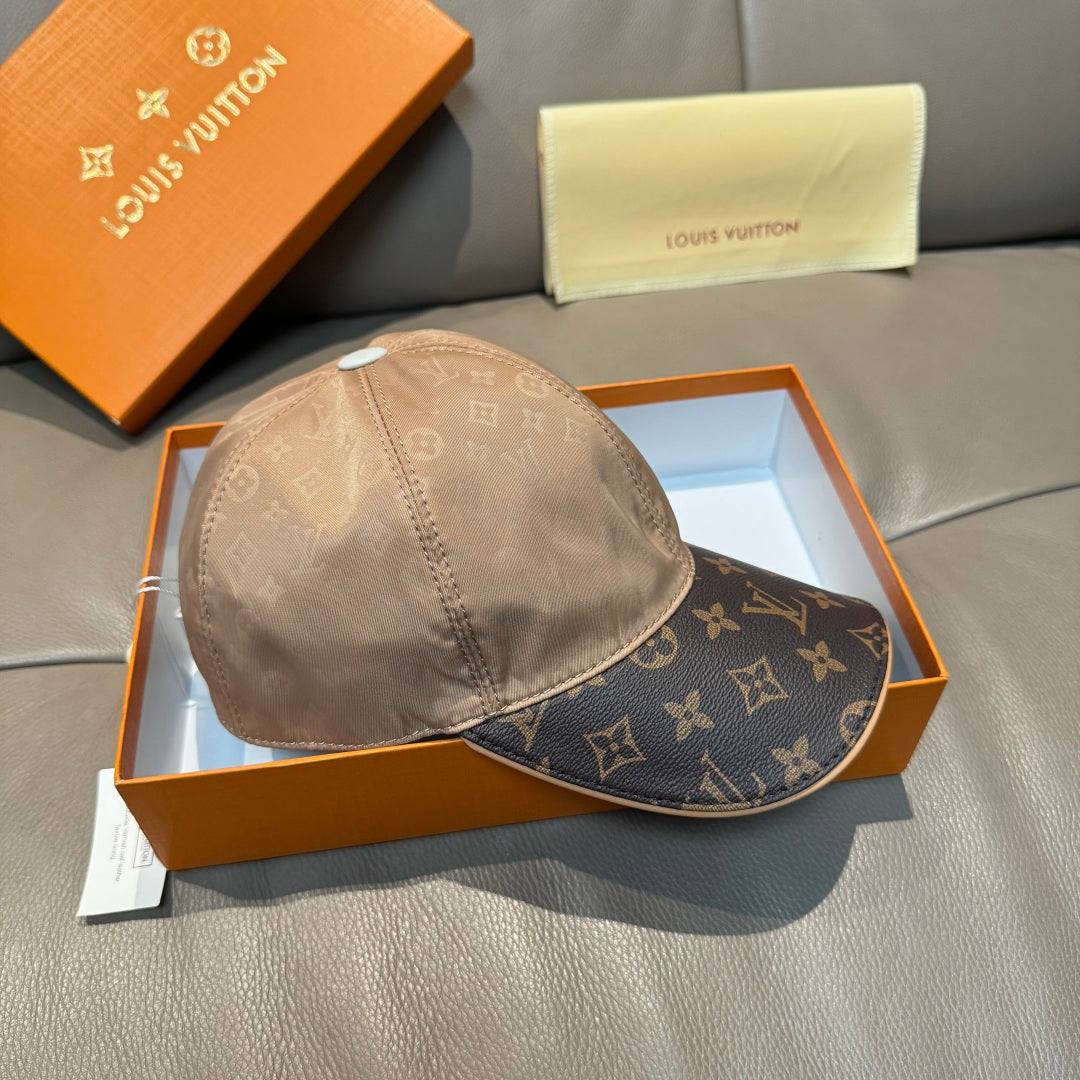 Louis Vuitton two-tone baseball cap with beige crown and dark monogram visor.