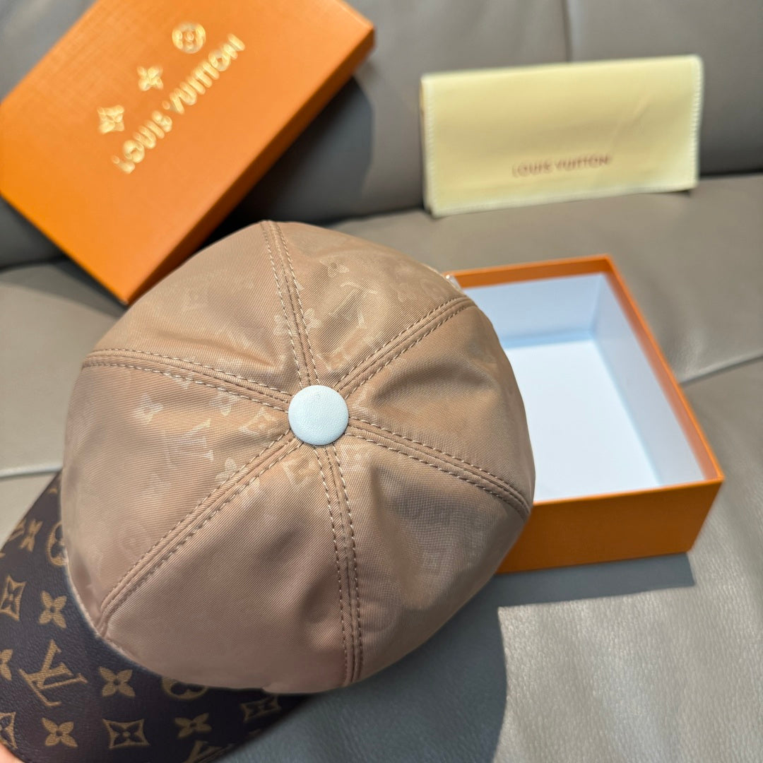 Louis Vuitton two-tone baseball cap close-up: beige crown with blue button detail.