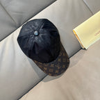 Louis Vuitton baseball cap in dark monogram fabric with brown logo side panels and button.