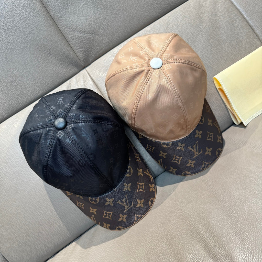 Pair of Louis Vuitton two-tone baseball caps: beige and dark monogram designs.