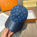 Blue monogram denim baseball cap in side view with curved brim and stitching
