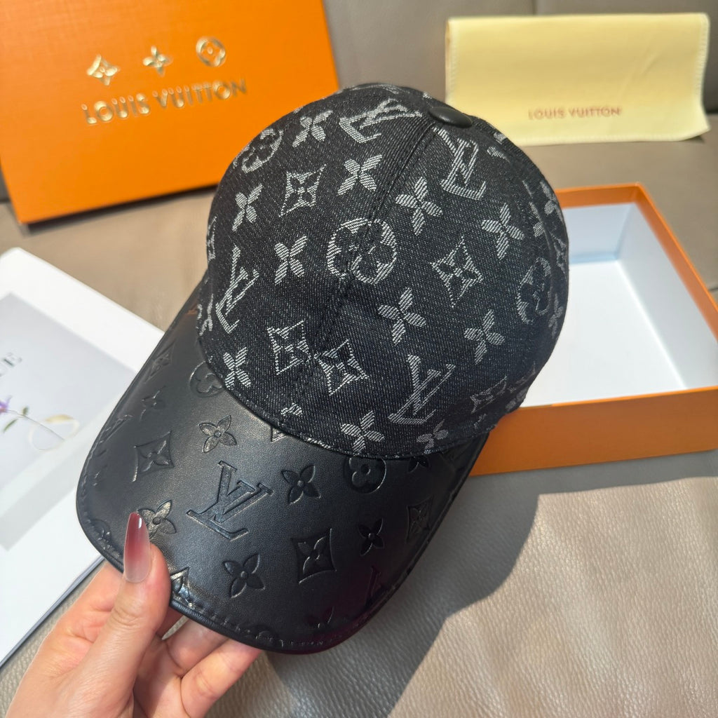 Louis Vuitton monogram cap with dark leather-look brim, handheld side view
