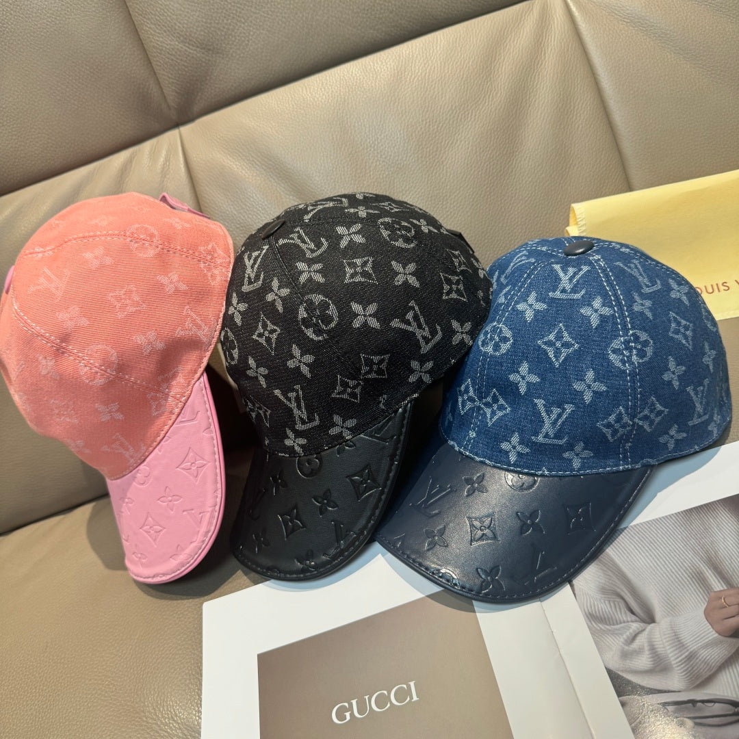 Louis Vuitton monogram caps in pink, black, and blue with curved brims