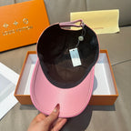 Louis Vuitton pink cap with black interior lining and adjustable chin strap