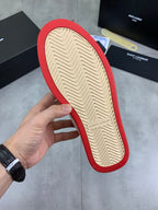 Shoe outsole with zigzag tread, red edge trim, and tan rubber center.
