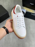 White lace-up sneaker with red collar trim and gum rubber sole.