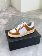 Brown suede and white low-top sneakers with white laces and off-white rubber sole.