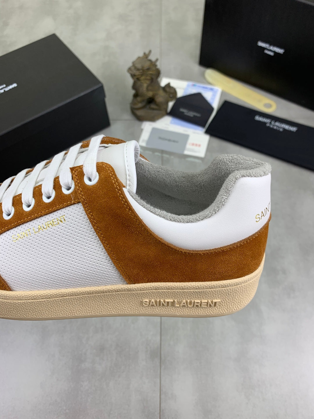 Brown suede and white sneakers with cushioned collar and SAINT LAURENT heel logo.