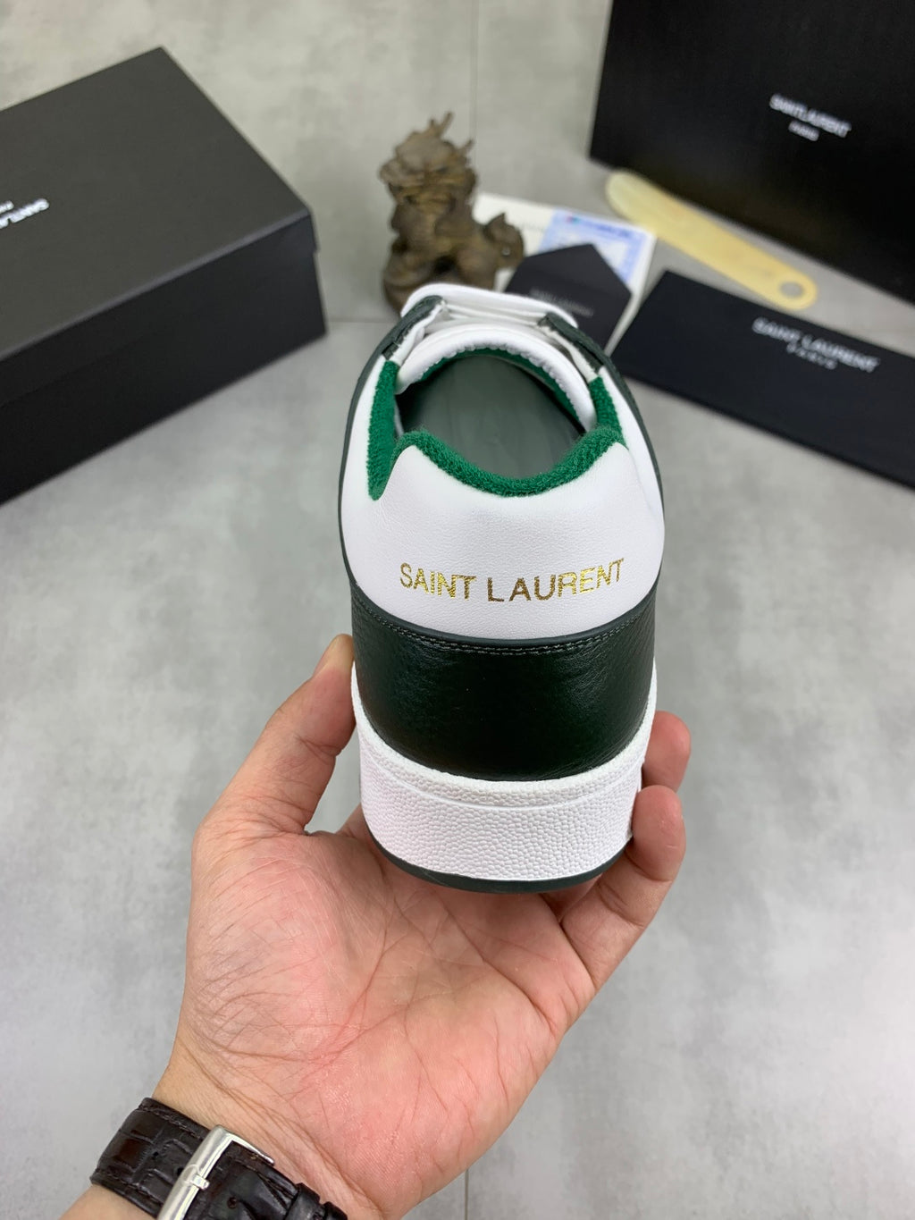 Luxury shoes heel view in white and dark green with green interior and textured sole