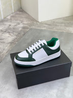 Luxury shoes white and dark green sneakers on a black box, white laces and rubber sole
