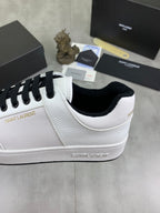 White low-top sneakers with black laces and black-trim collar