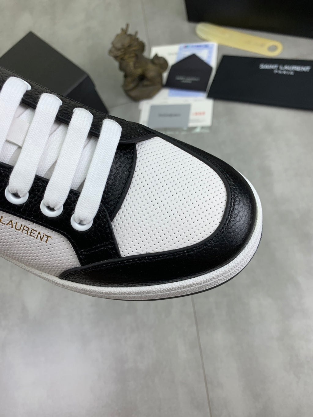 YSL unisex sneaker toe, black leather trim over white textured panels