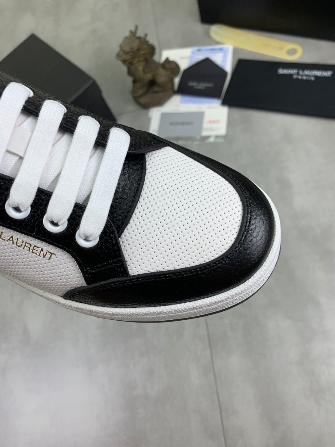 YSL unisex sneaker toe, black leather trim over white textured panels