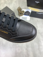 Black lace-up sneaker with perforated-texture side panel and dark rubber sole
