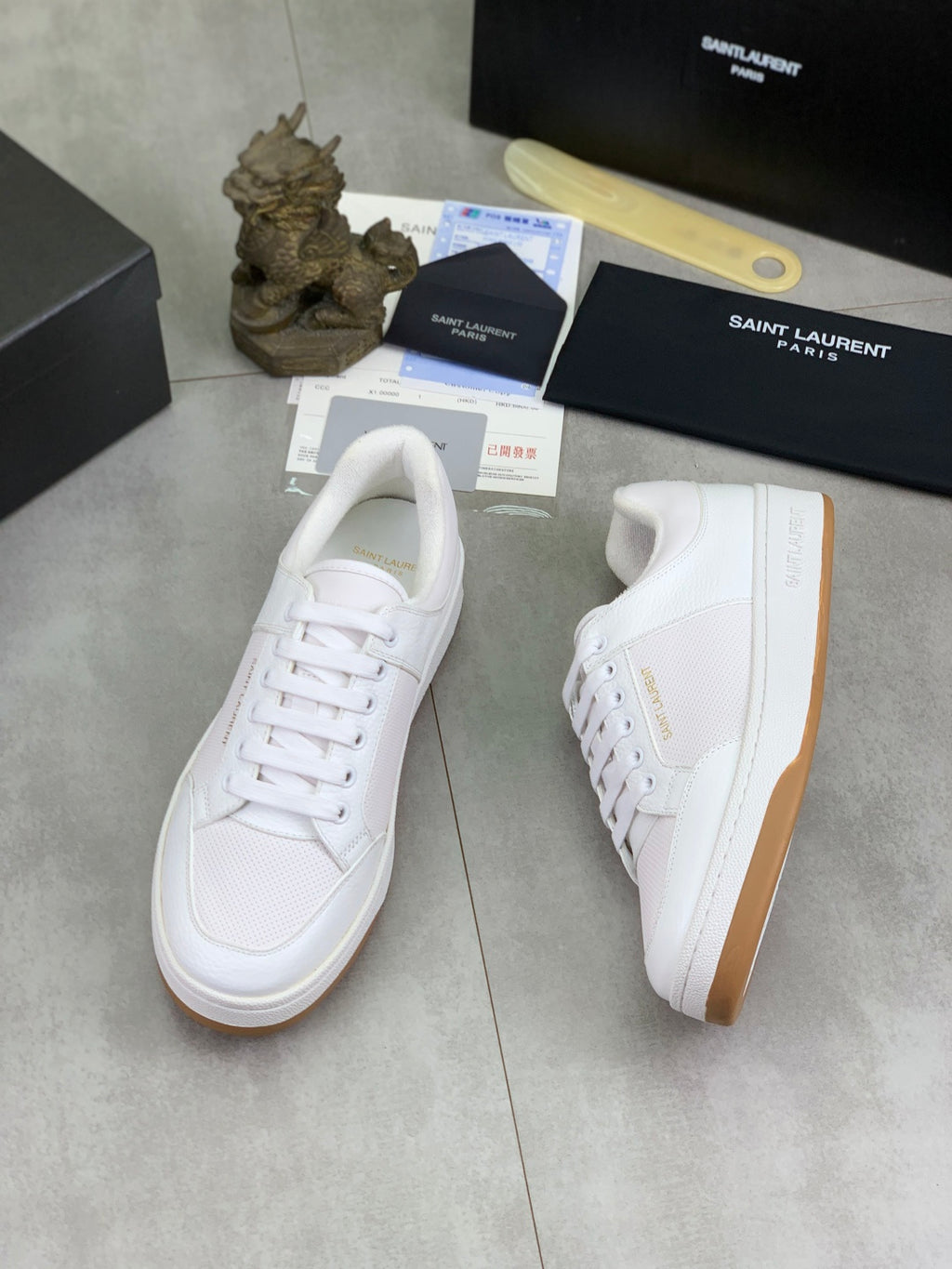 White low-top lace-up sneakers with gum-style sole and side logo