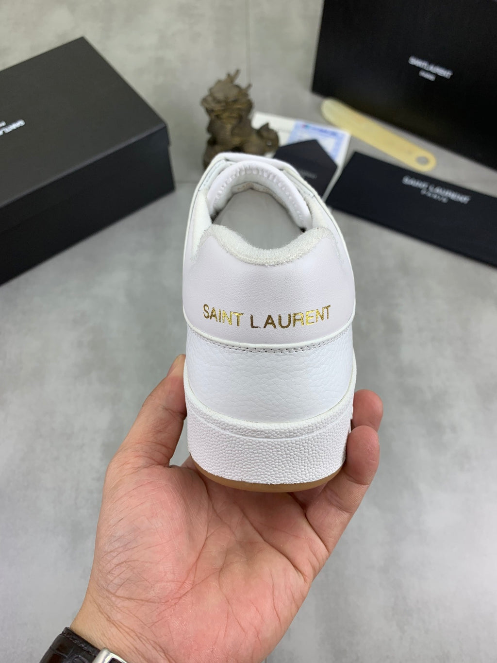 White sneaker heel with back logo patch and padded collar