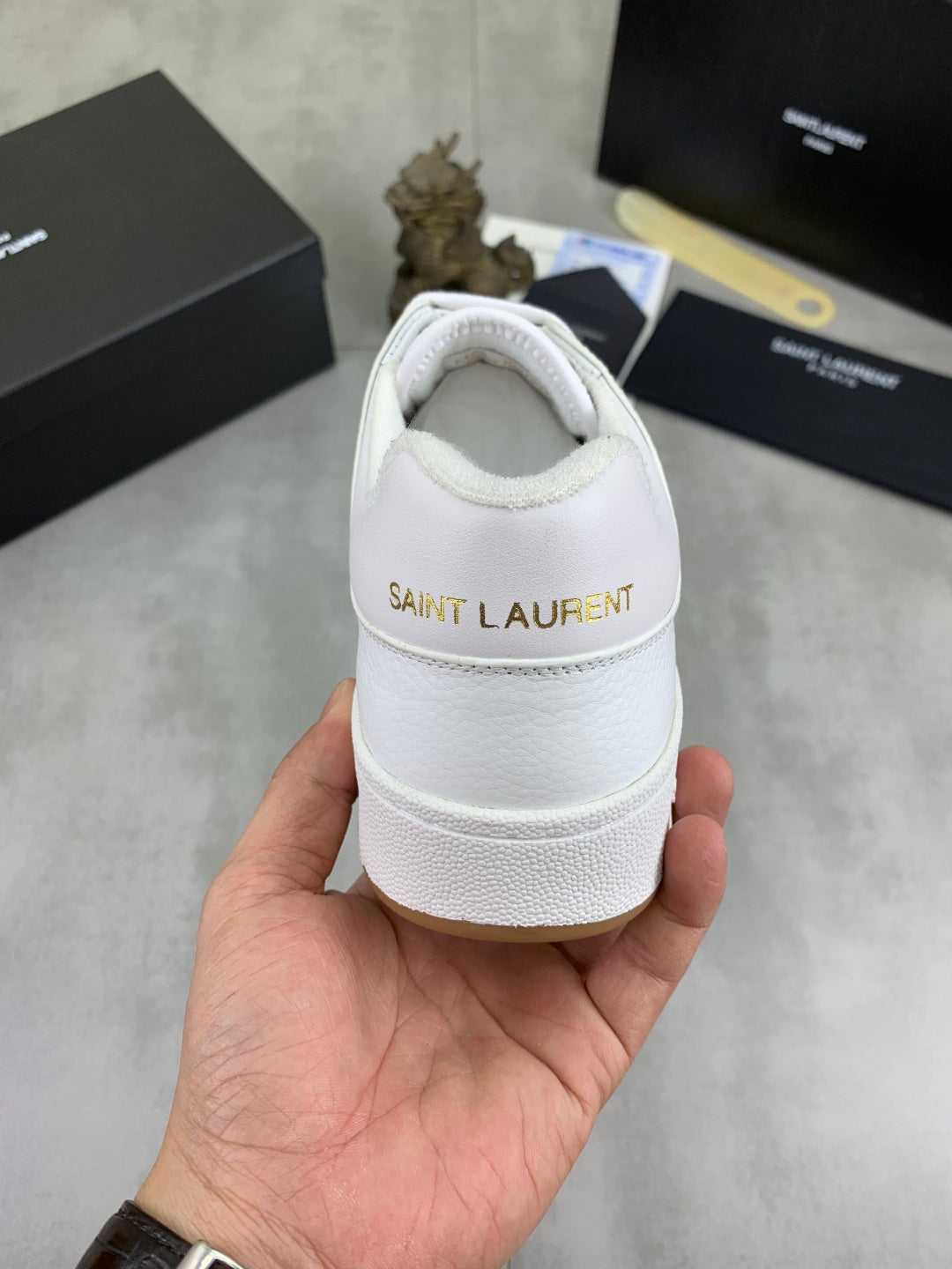 White sneaker heel with back logo patch and padded collar