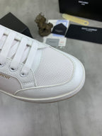 White sneaker toe and lace panel with subtle perforation texture