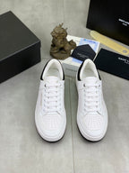 Pair of white unisex low-top sneakers with perforated toe and lace-up front
