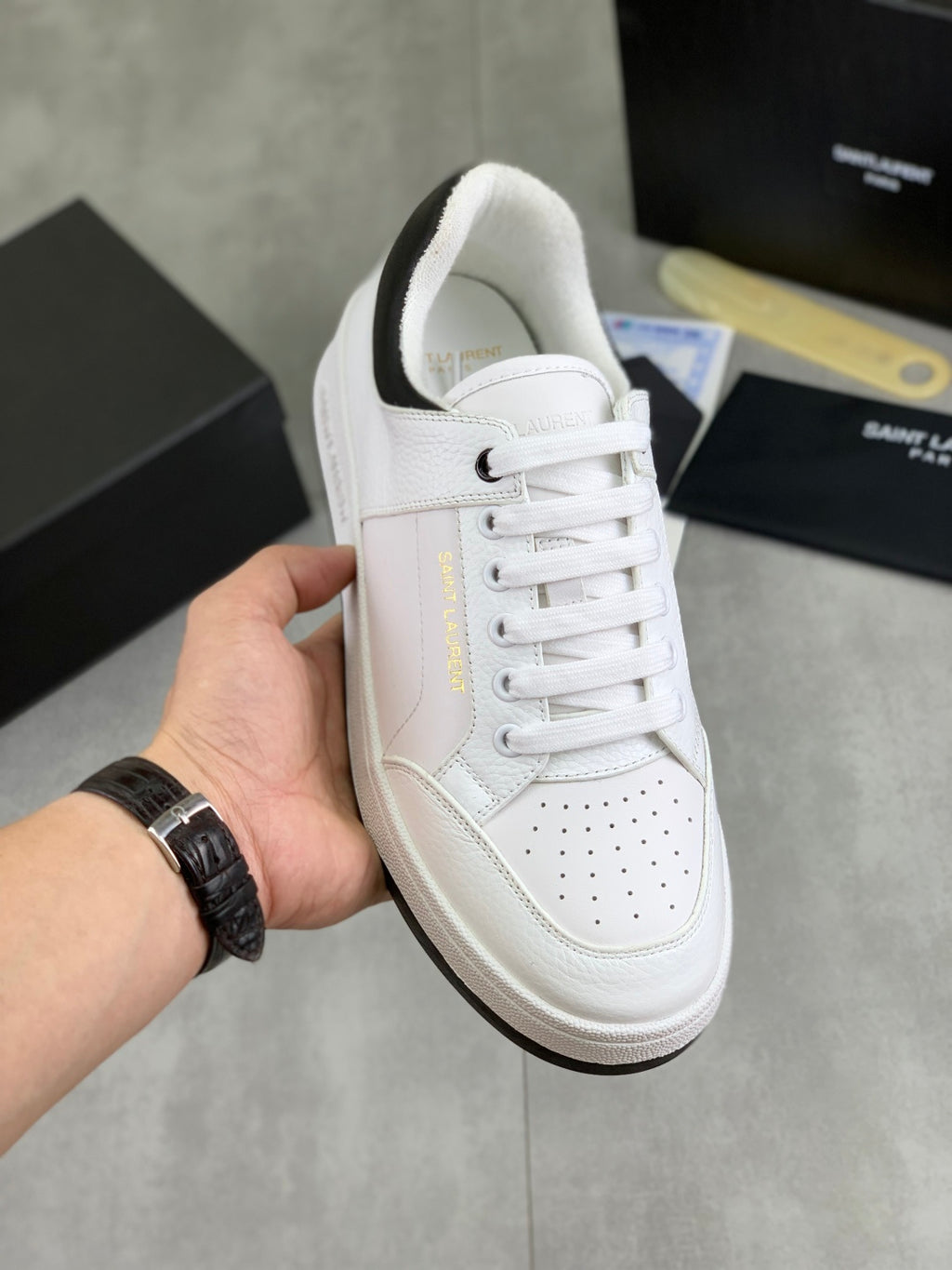 White unisex low-top sneakers with perforated toe and white laces