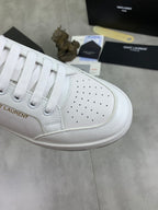 White unisex sneaker with perforated quarter panel and white lace-up closure