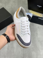 White and navy low-top sneakers, lace-up with perforated toe and gum sole