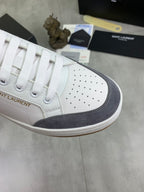 White sneaker toe cap with perforations and navy suede side panel