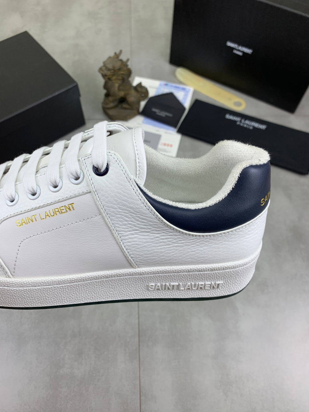 YSL unisex luxury shoes, white sneakers with navy-lined collar and embossed side logo