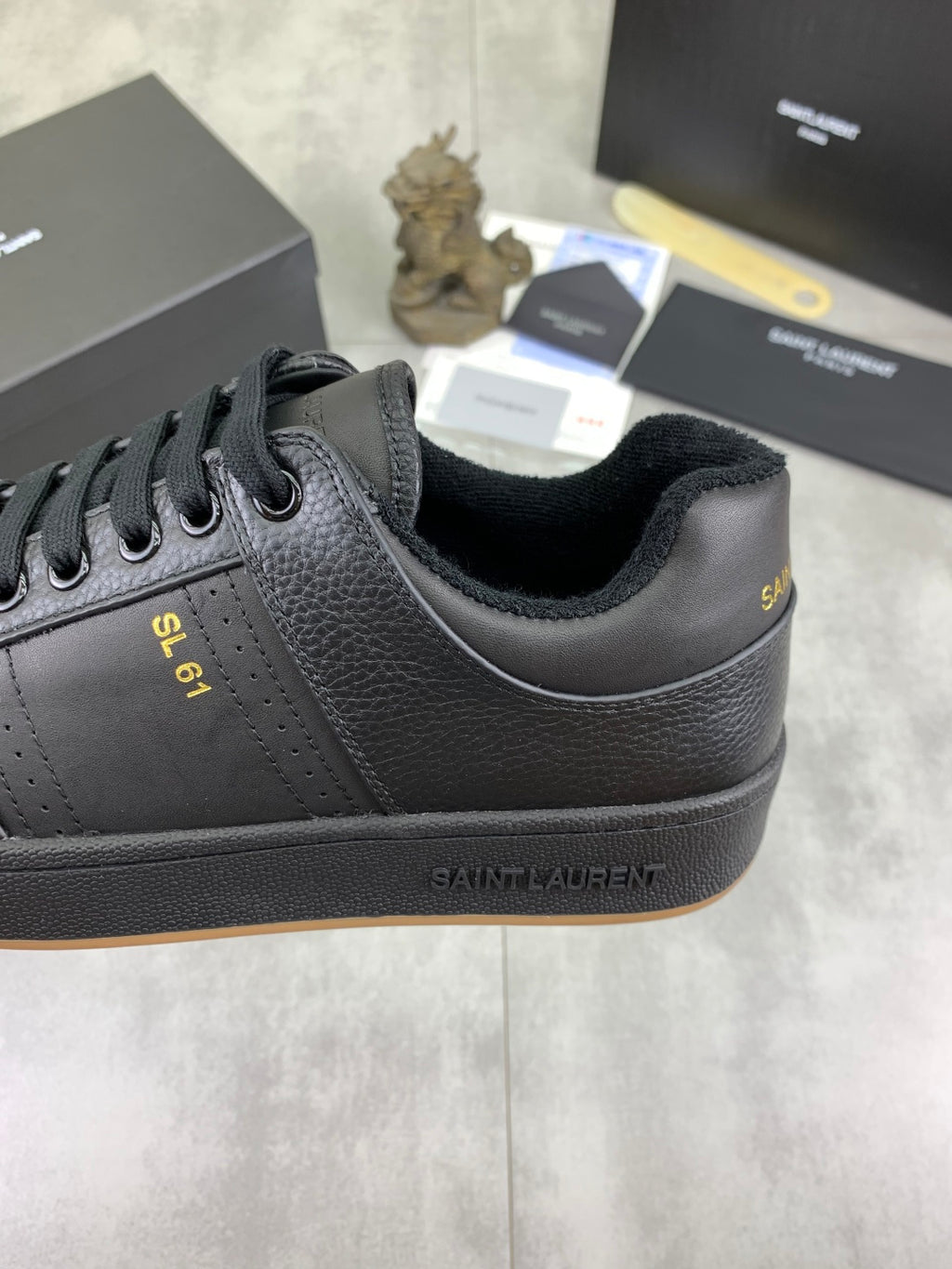 YSL unisex lace-up leather sneaker side view with branding and gum sole, dark blue-black