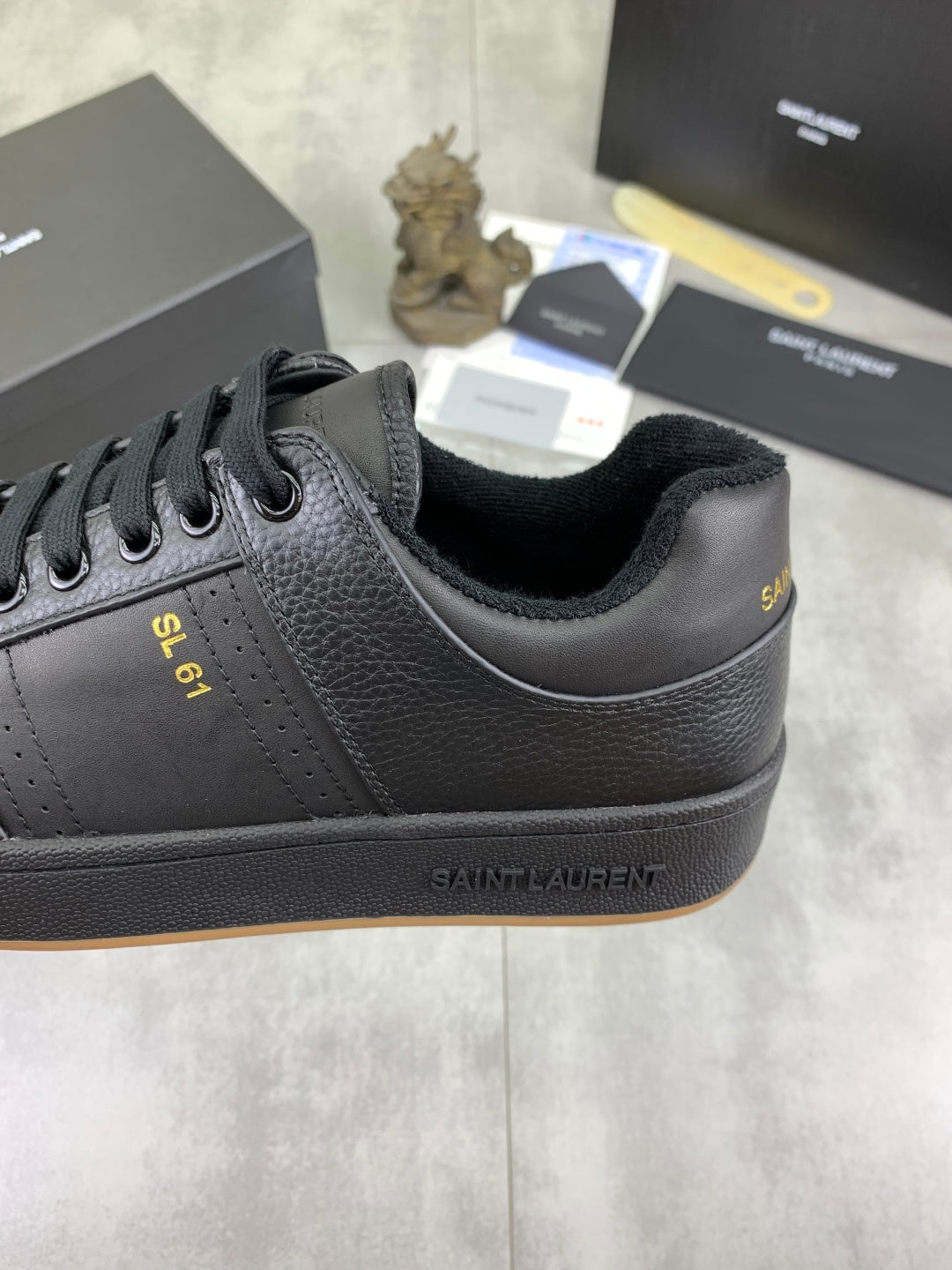 YSL unisex lace-up leather sneaker side view with branding and gum sole, dark blue-black