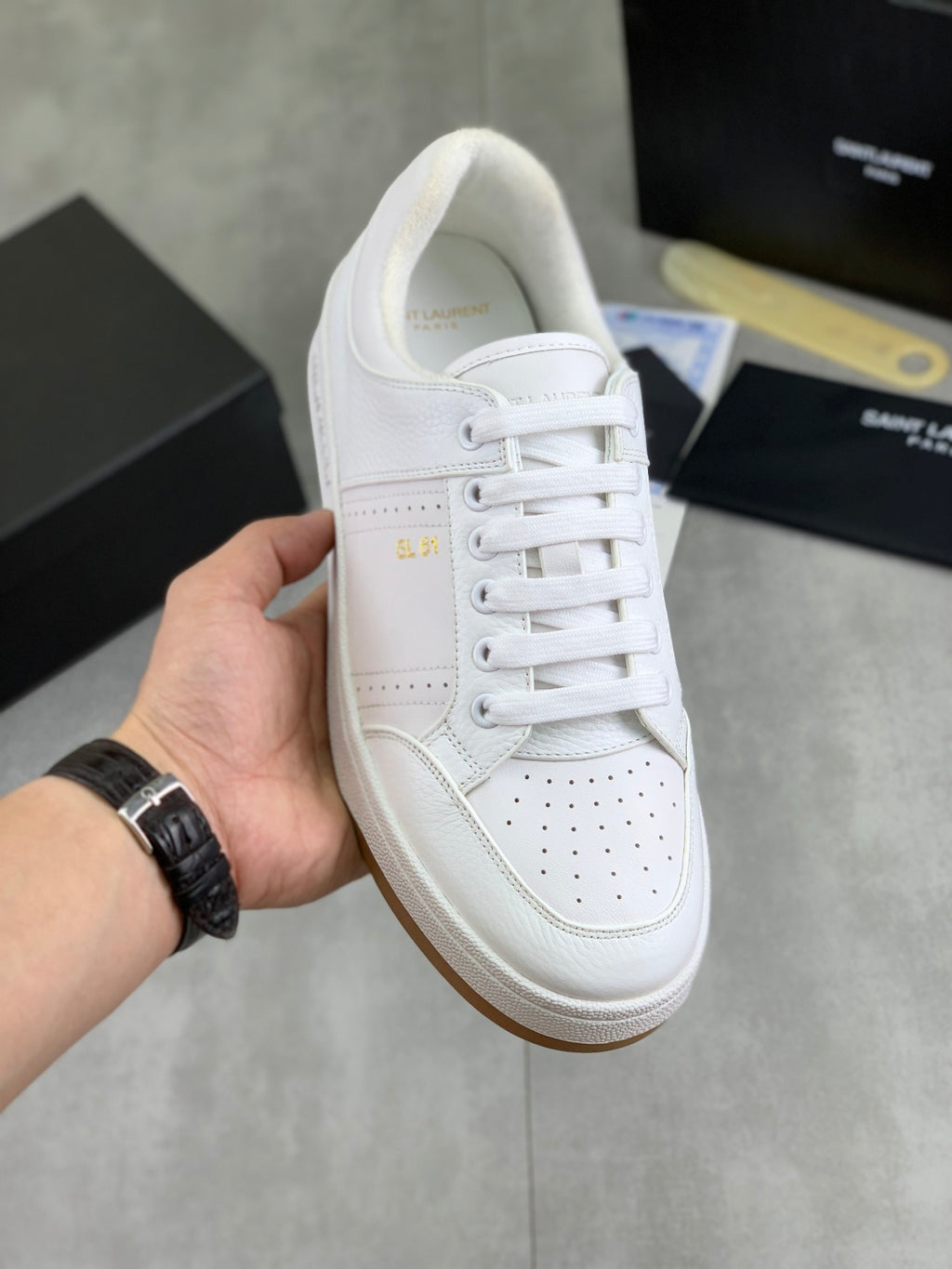 White lace-up sneakers with perforated toe panel and stitched side detail