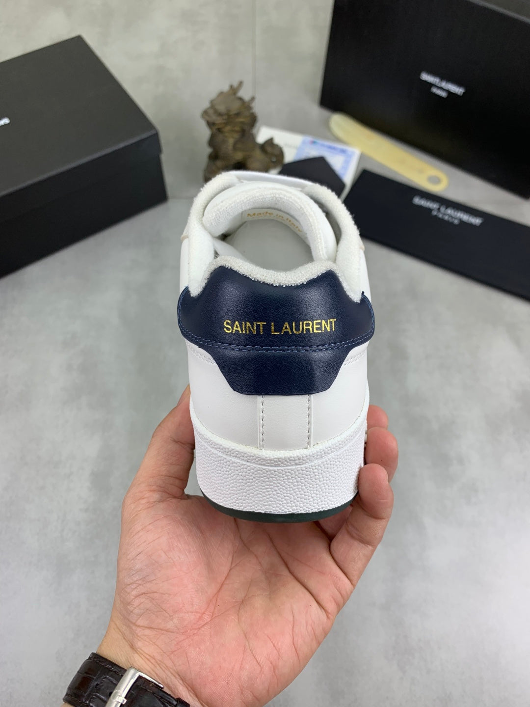 Off-white sneaker heel with navy collar band and Saint Laurent text