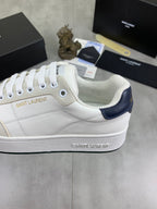 Off-white leather sneaker with Saint Laurent branding and navy collar panel