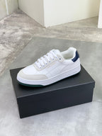 Off-white low-top leather sneaker with white laces and navy side detail