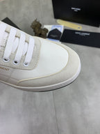 Off-white leather sneaker side panel with white laces and light stitching