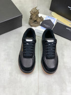 Pair of black lace-up low-top sneakers with rubber sole