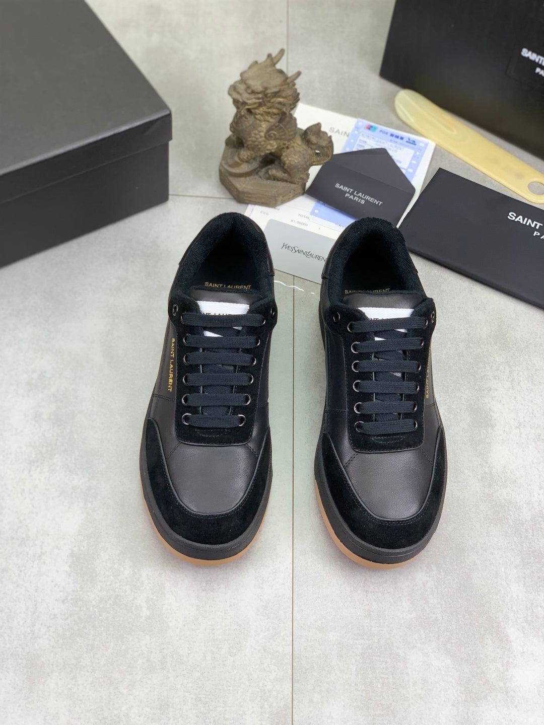 Pair of black lace-up low-top sneakers with rubber sole